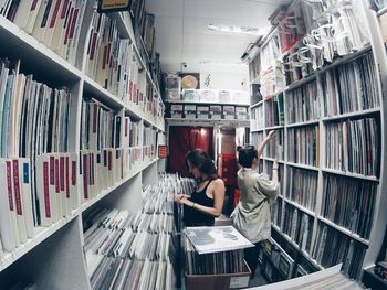 High angle view of women choosing music record at store