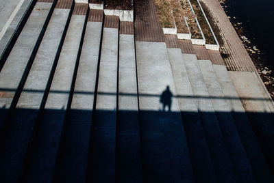 Shadow of person walking on staircase