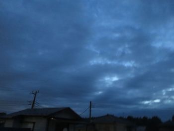 Low angle view of silhouette building against sky