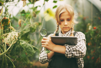 Portrait of happy woman holding plants