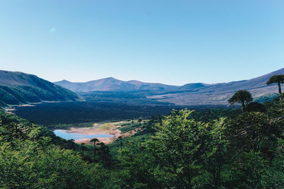 Scenic view of mountains against clear blue sky