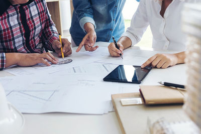 Close-up of business people working in office