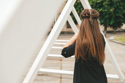 Woman standing by staircase