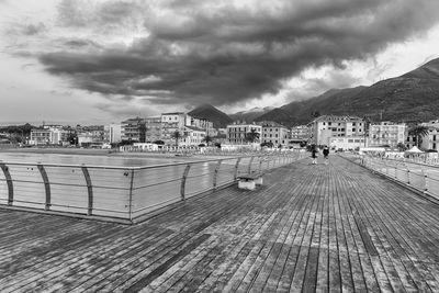 View of cityscape against cloudy sky