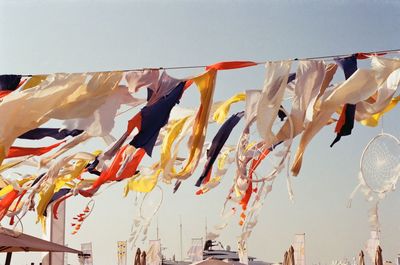 Low angle view of clothes drying against sky