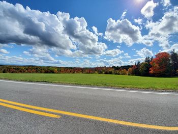 Scenic view of road by landscape against sky