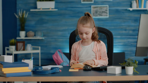 Side view of girl looking at table