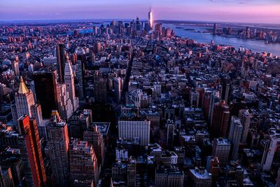 High angle view of city lit up at night