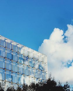 Low angle view of factory against blue sky