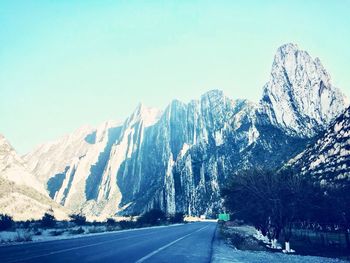 Road passing through snow covered mountains