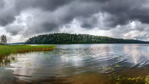 Scenic view of lake against cloudy sky