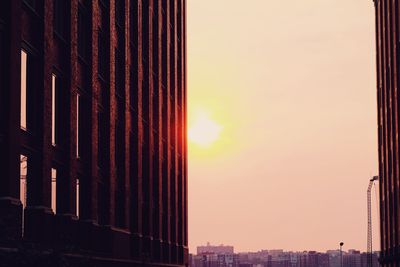 Modern cityscape against sky during sunset