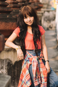 Portrait of young woman standing outdoors