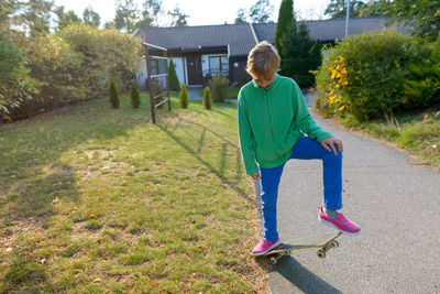 Full length of woman on grass against trees
