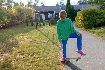 Full length of woman on grass against trees