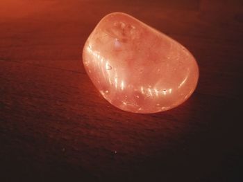 Close-up of illuminated lamp on table