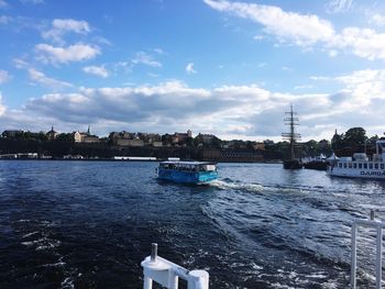 Scenic view of river by buildings against sky