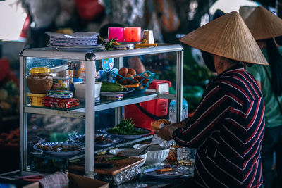 Rear view of man for sale at market