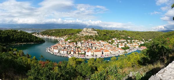 View of townscape against cloudy sky