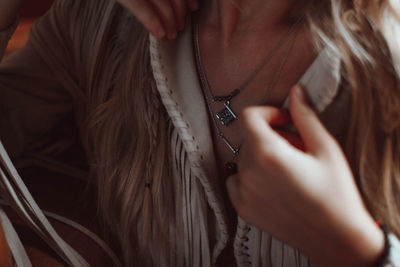 Details of beige jacket and accessories in hippie and boho style