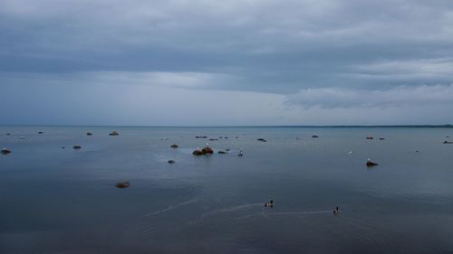 Scenic view of sea against cloudy sky