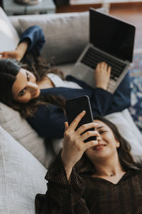 Midsection of woman using mobile phone