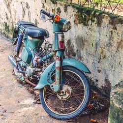 Old bicycle parked on wall