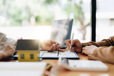 Midsection of woman using laptop on table