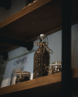 Low angle view of glass bottles on table at home