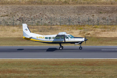 Side view of airplane on airport runway