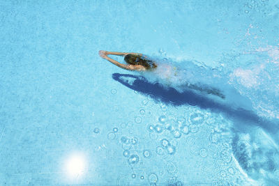 Woman diving underwater in swimming pool