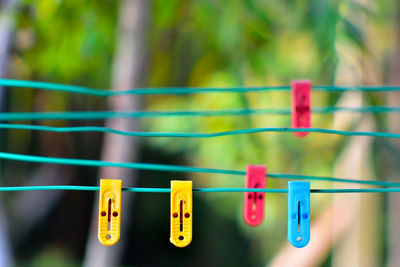 Close-up of colorful clothespins hanging on clothesline