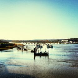 Pier on sea against clear sky