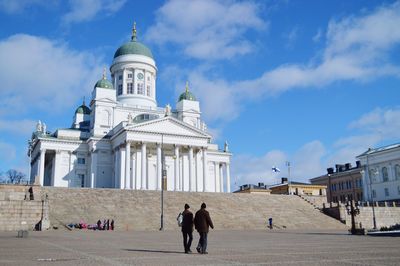 Low angle view of building against cloudy blue sky