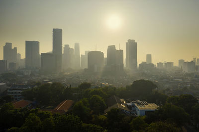 Buildings in city against clear sky