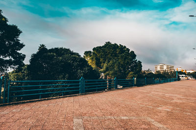 Bridge over river in city against sky