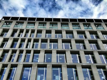 Low angle view of building against cloudy sky