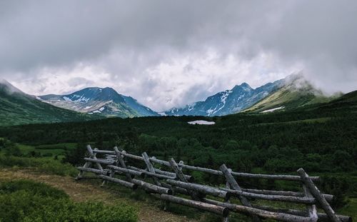 Scenic view of field and mountains against sky