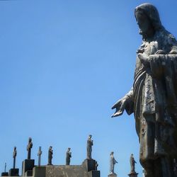 Low angle view of statue against blue sky
