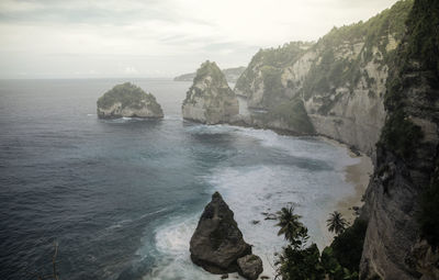 Scenic view of rocks in sea against sky