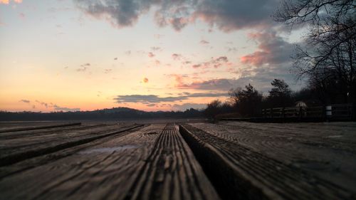 Railroad tracks against sky during sunset