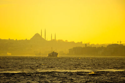 Scenic view of sea against orange sky