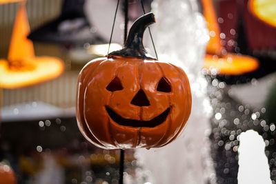 Jack o lantern hanging against fountain during halloween