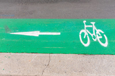 High angle view of arrow sign on road