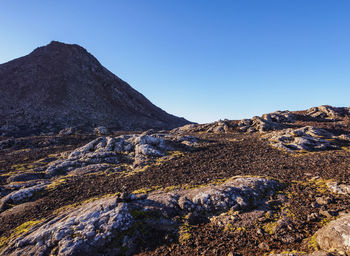 Scenic view of mountains against clear blue sky