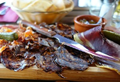 Close-up of tapas and kitchen knife on cutting board