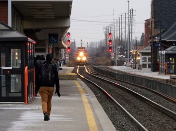 Full length of woman on train at railroad station platform