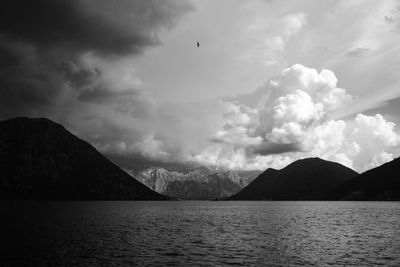 Scenic view of sea and mountains against sky