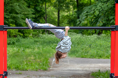 Rear view of woman standing in playground