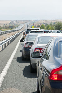 Traffic on road in city against clear sky